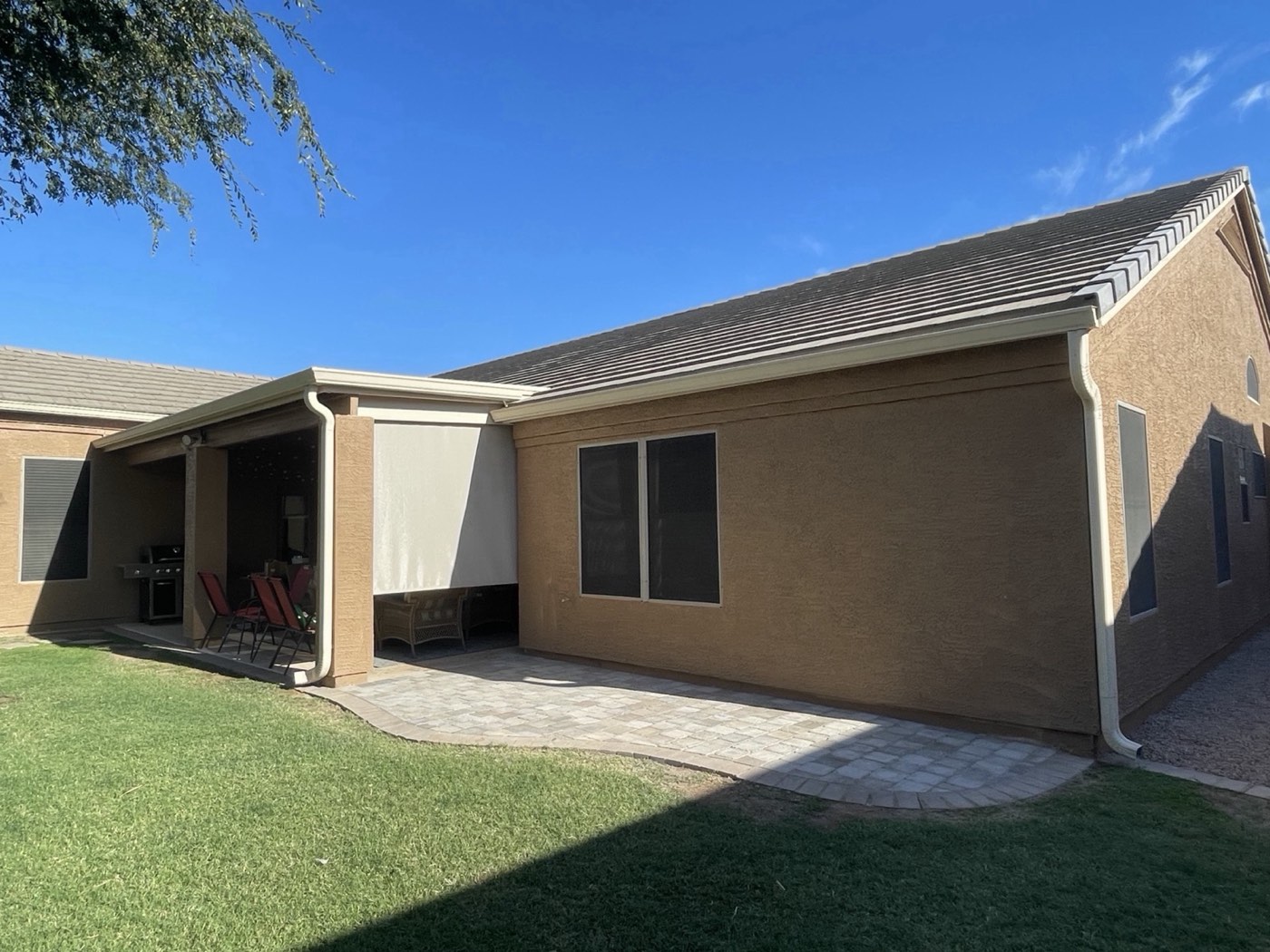 Stucco home backyard with paver patio