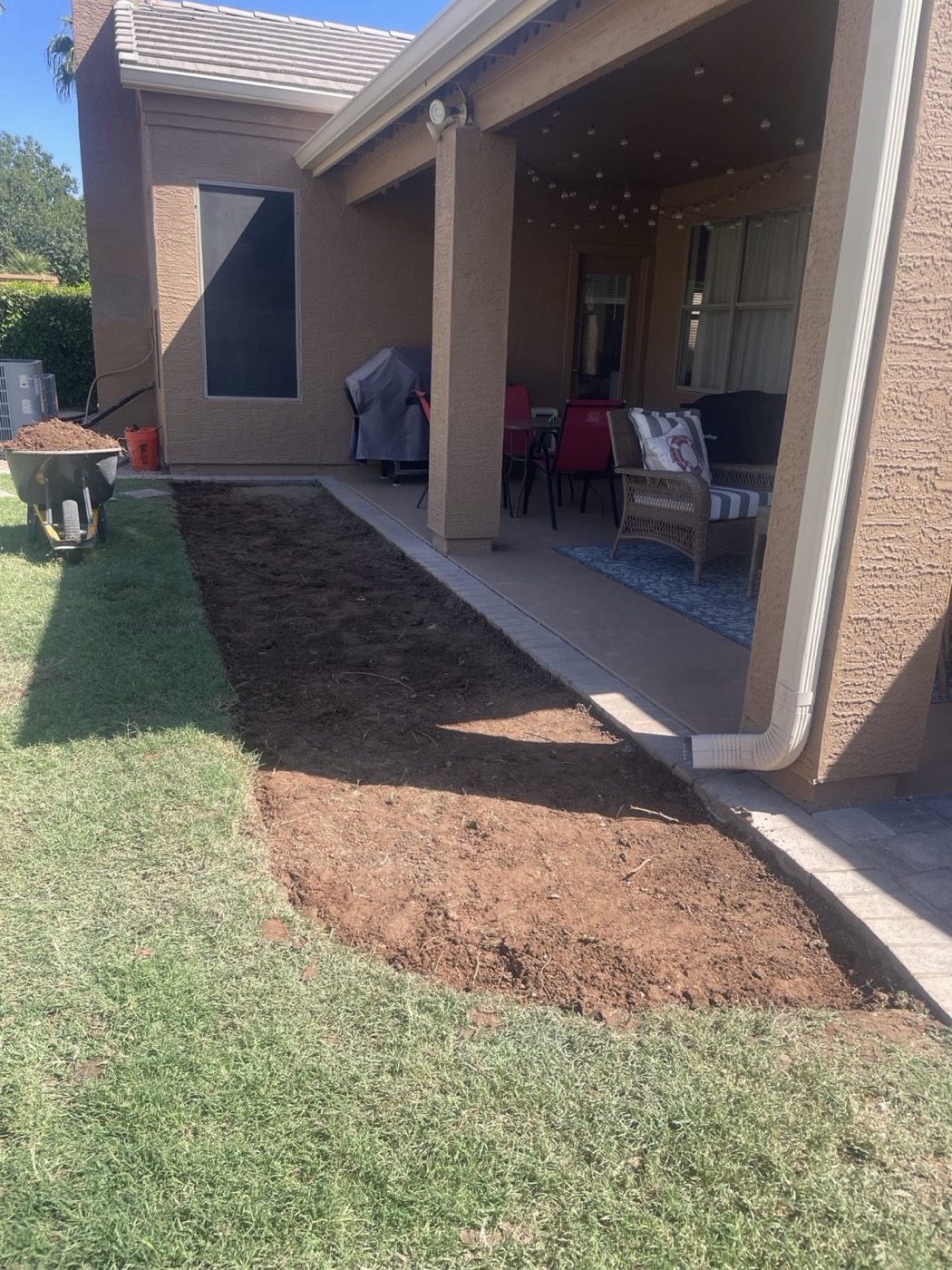 Bare dirt area before sod install